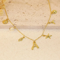 Collar con letra en bambú, estrella de mar y concha