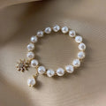 Pulsera con colgante en oro blanco, perla y girasol